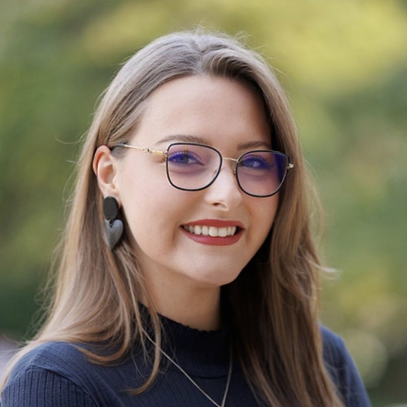 A woman poses for a photo outdoors