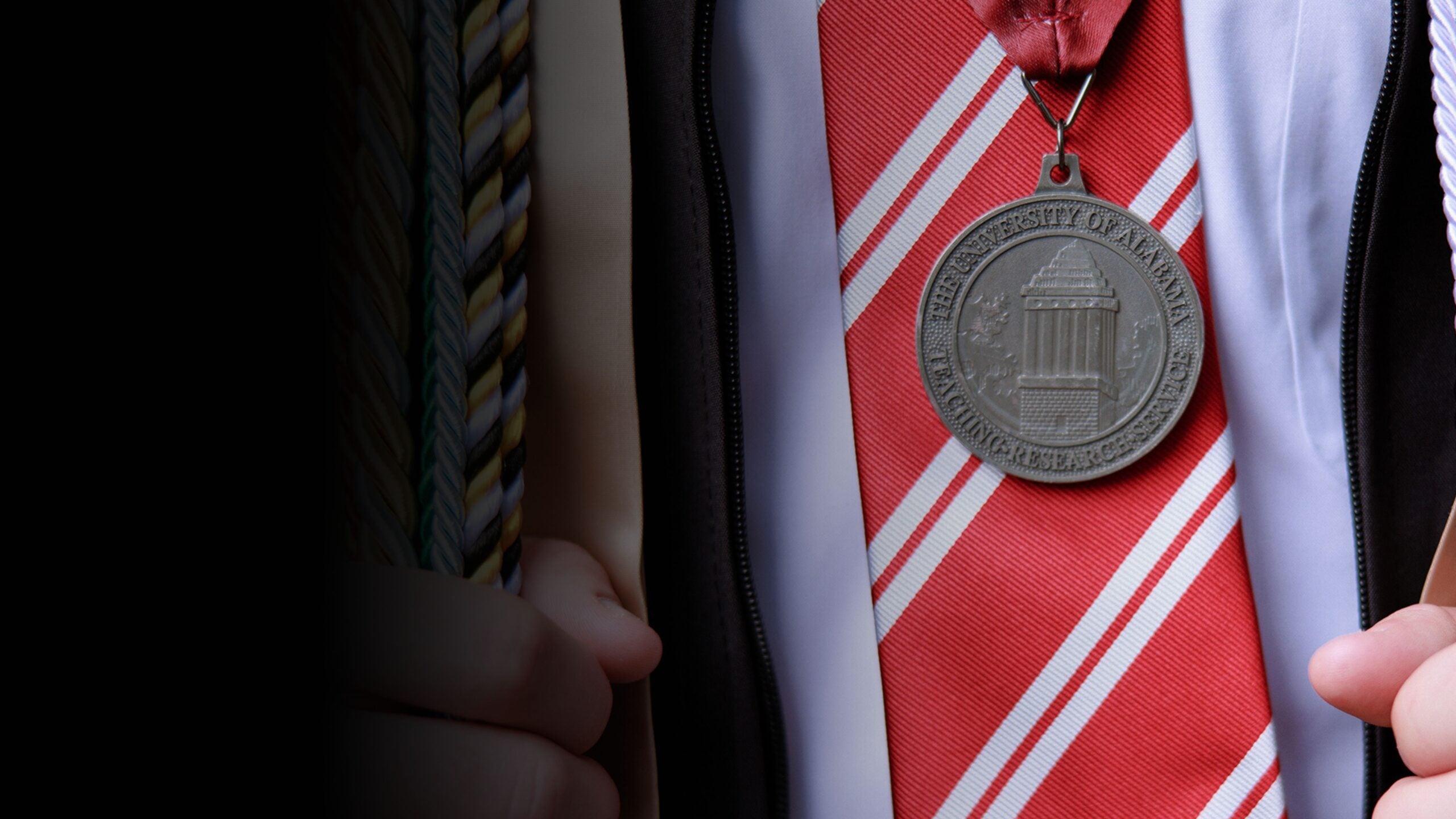 A close-up photo of a bronze medallion laid against a necktie